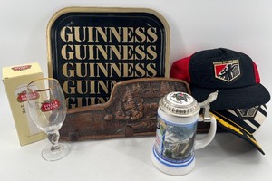lot 454 image: Beer Advertising Collectibles Lot with Guinness Tray, Stella Artois Glass, Stein, Wall Rack, and House of Holbein Hats
