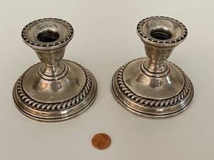 lot 52 image: Pair of Sterling Weighted Reinforced Candle Holders