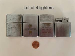 lot 69 image: Lot of 4 Vintage Metal Lighters Including Zippo and U.S.S. Collett Anniversary