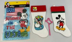 lot 53 image: Misc. Mickey Mouse Collectibles Including Christmas Stockings & Small Flag (NIB)