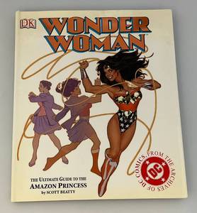 lot 113 image: WONDER WOMAN The Ultimate Guide The Amazon Princess 2003 Hard Caver With Dust Jacket (Dust Cover Has Tears On Back )