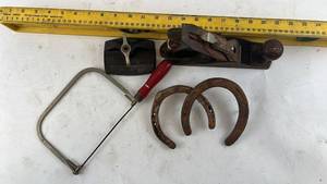 lot 272 image: Collection of Vintage Hand Tools Including Wood Plane, Horseshoes, & Vintage Twilit Cast Iron Single Hole Paper Drill (Yellow level NOT Included)