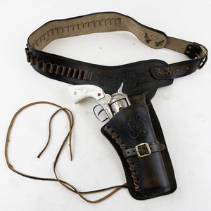 lot 175 image: Nichols Stallion 45  MKII Toy Cap Gun with Leather Holster Belt