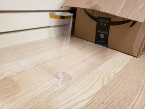 lot 13 image: Box full of plastic gold rimmed champagne glasses