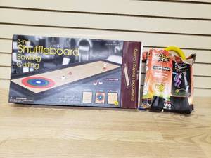 lot 24 image: Stomp Rocket and 3-in-1 Shuffle Board, Bowling, Curling Set