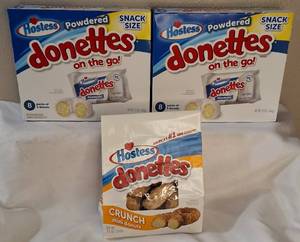 lot 16 image: HOSTESS LOT  (2) Hostess Powdered Donettes on the go & (1) Bag of Hostess Donettes Crunch Mini Donuts