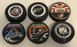 lot 149A image: (6) NHL Official Game Pucks - Lightning, Sabres, Canucks, Flyers, Capitals, Coyotes