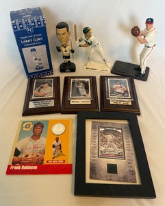 lot 209A image: Lot of 9 Misc Sports Memorabilia - 2 Figures (Canseco and Maddux) 2 Bobbleheads (Gura and Comrie) 3 Plaques (Mantle, Morneau, Cuddyer) Robinson Coin, and Mussina Game Used Jersey Card