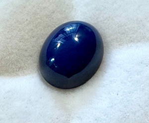 lot 28J image: 6.83 Carat Synthetic Blue Star Sapphire Oval Cabochon
