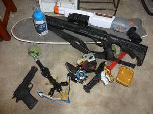 lot 79 image: Group of toy guns and swords and a skateboard