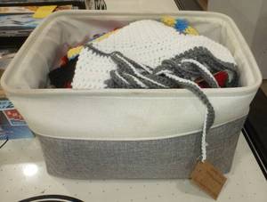 lot 82 image: Basket of home knitted hats and tops