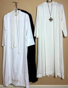 lot 142 image: Set of 2 Long White Albs with Braided Belt & Crucifix - Gaspard & Co. One Medium and One XL