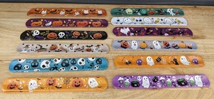 lot 870 image: 48 Brand New Halloween Snap Wrist Bands in Assorted Designs