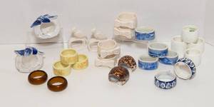 lot 84 image: Set of 25 Napkin Rings  Ceramic, Amber Glass, and Shell
