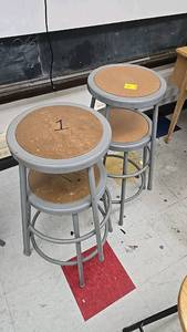 lot 82 image: (4) Gray Metal Frame Round Stools with Footrest and Stackable Design