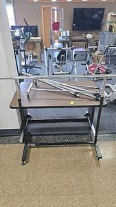 lot 117 image: Adjustable Chrome Garment Rack with Collapsible Side Arms and Wheels, table included.
