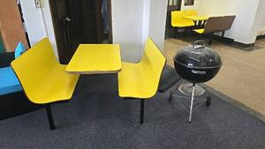 lot 122 image: Yellow 4-Seater Dining Booth Set and weber charcoal grill.
