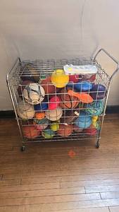 lot 156 image: Metal Wire Storage Basket with Assorted Sports Balls, Rolling Casters