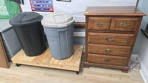 lot 313 image: Rolling Wooden Platform with (2) 32 Gallon Trash Cans, wooden dresser with drawers.