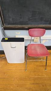 lot 609 image: Hathaspace HSP002 Air Purifier, Covers 1500 sq. ft., True HEPA, 100W and red chair.
