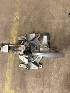 lot 136 image: 12 Sliding Compound Miter Saw. Needs Handle and May need other Parts, Blade Included. Online Manual Parts List Available
