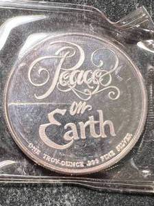 lot 48 image: 1 TROY OZ .999 FINE SILVER PEACE ON EARTH ROUND