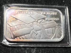 lot 51 image: 1 TROY OZ .999 FINE SILVER GRADUATION 1989 BAR