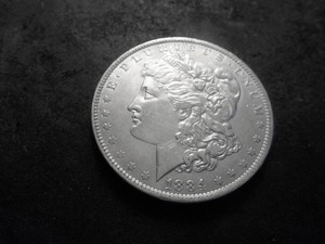 lot 28 image: 1884 O Morgan Silver Dollar