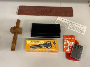 lot 128 image: Vintage Tools and Collectibles Lighthouse Flash Magnifier, Slide Rule, Hand Warmer