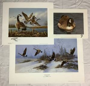 lot 26 image: Trio of Canadian Geese Prints featuring Solitude by Jerry Gadamus, Crossing the Snowfield by Micheal Bargelski, and Good Morning by James A Meger