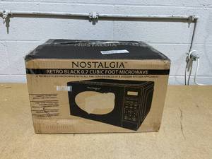 lot 75 image: Nostalgia 0.7 Cubic Countertop Microwave Oven