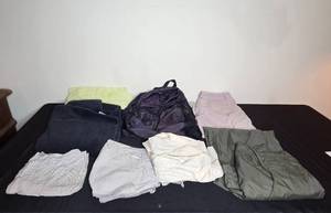lot 97 image: Assortment of Clothing and Gear Including Pants, Backpack, and Towels