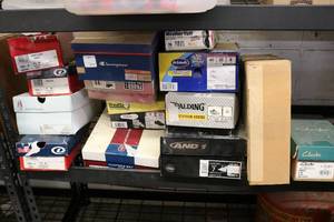 lot 88 image: shelf of unsold and unclaimed shoes...