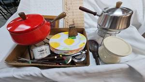 lot 138 image: Fondue Sets along with utensils, plates and Sternos