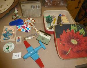 lot 113 image: Vintage airplane with folding wings, RCAVictor radio, jewelry, trick magnetic dogs, hair pin, Shoe horns