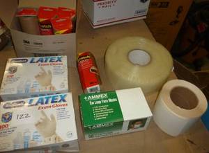lot 122 image: Office supplies - 5 rolls of 3M cover up tape, 2 boxes of latex gloves, box of masks, large roll of tape and roll of labels