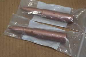 lot 125 image: 2 Copper Novelty 50 BMG Rounds