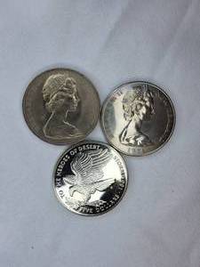 lot 43 image: Three large commemorative world coins in nice condition, from different countries.