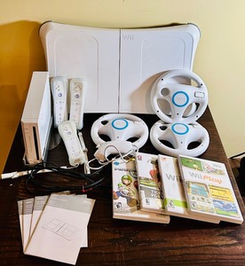 lot 178 image: Wii Gaming Console, Remote Controls, Trio of Wii Wheels, Wii Balance Board and Various Games