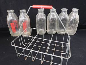 lot 17 image: VINTAGE METAL  MILK CARRIER WITH 6 GLASS MILK BOTTLES
