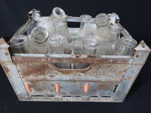 lot 24 image: LARGE METAL MILK CRATE W 12 BOTTLES