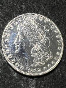 lot 69 image: 1889 US MORGAN SILVER DOLLAR CLEANED