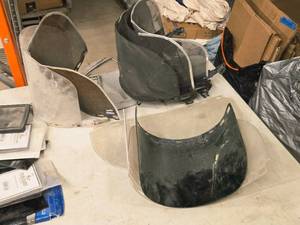 lot 32 image: (4) Clear Faceshields, (1) Tinted Faceshield, (4) Brackets with Mesh Shields, (1) Bracket with Clear Faceshield