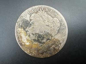 lot 26 image: Obscured Date Morgan Silver Dollar