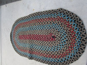lot 63 image: Oval Braided Throw Rug