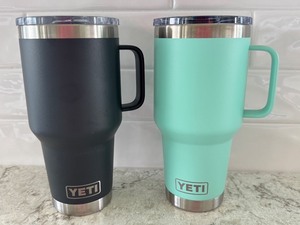 lot 22 image: Pair of YETI Rambler 20 oz Mugs with Lids - Black and Seafoam