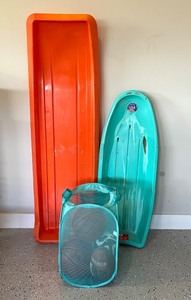 lot 222 image: Lot of 2 Sleds, 2 Basketballs, Football, Soccer Ball, and Laundry Hamper