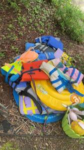 lot 332 image: Collection of Life Jackets, Pool Floats, and Garden Decor