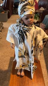 lot 382 image: Handcrafted African-Inspired Porcelain Doll in Traditional Clothing