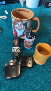 lot 592 image: Mixed Assortment Grumpy Mug, Zippo Accessory, and More